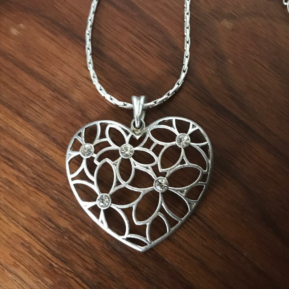 Openwork matte silver tone heart pendant necklace with rhinestone accents